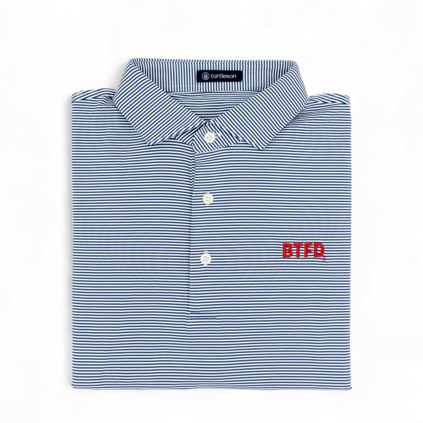 Folded blue and white striped golf shirt with 'BTFD' logo on a white background
