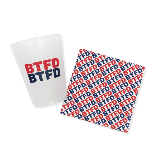 White frosted cup with 'BTFD' text and matching napkin on a white background