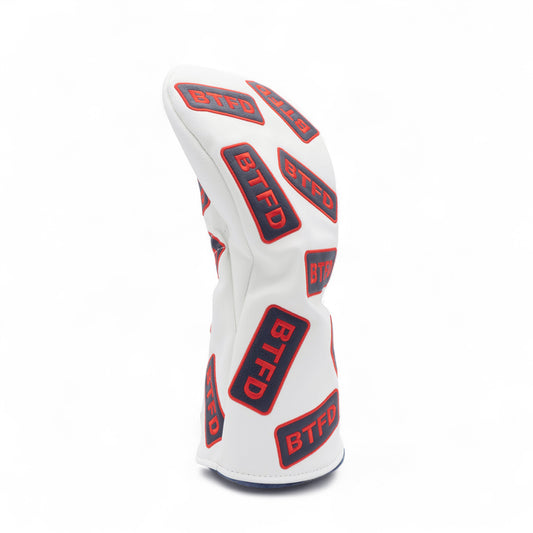 Golf driver cover with navy and red embroidered 'BTFD' patches on white background