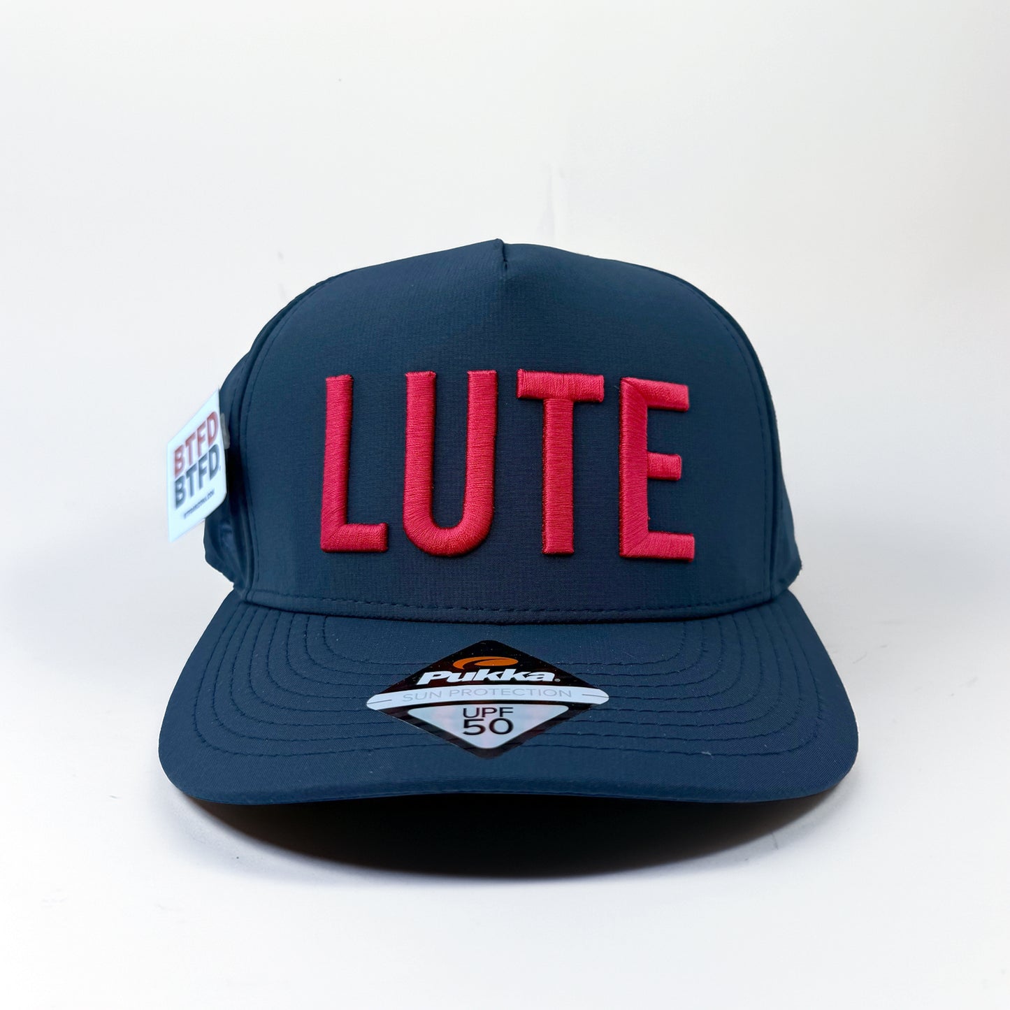 Blue cap with red 'LUTE' text on a white background