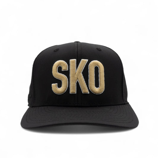 Black cap with 'SKO' embroidered in gold on a white background