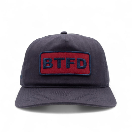 Navy blue cotton twill cap with a red and blue 'BTFD' embroidered patch on a white background