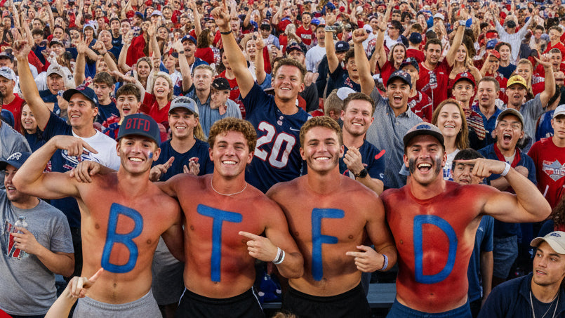 Group of college men with 'BTFD' painted on their chests in a stadium setting