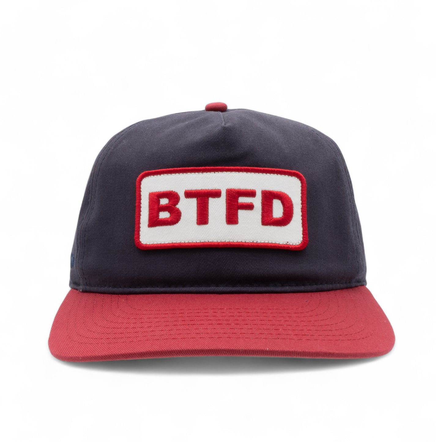 Navy and red cotton twill cap with embroidered 'BTFD' patch on a white background