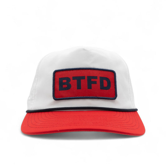 a white cap with a red bill, a red and blue 'BTFD' patch