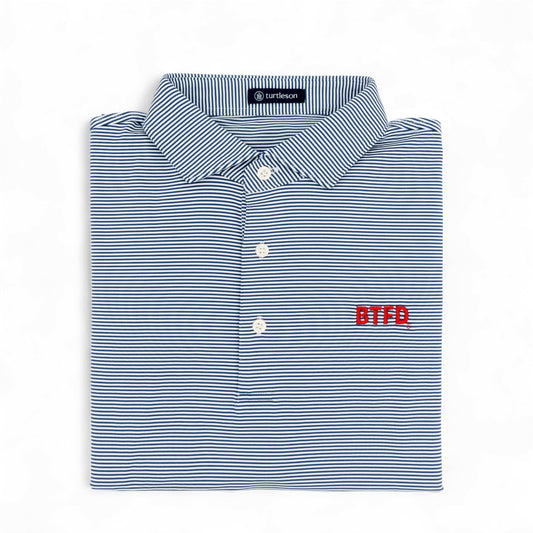 Folded blue and white striped golf shirt with 'BTFD' logo on a white background