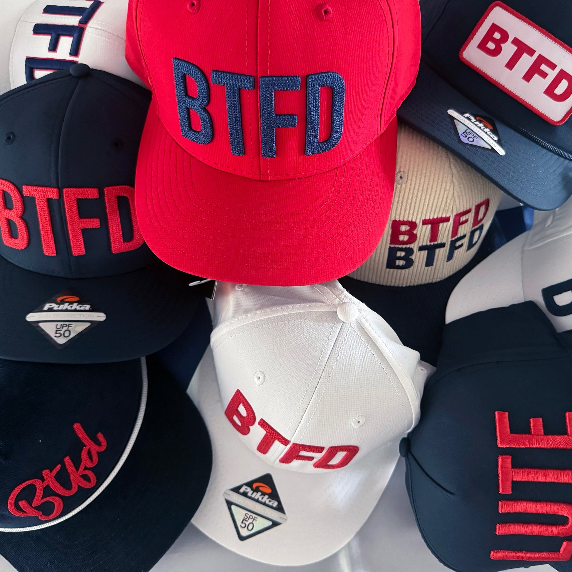 Collection of caps with 'BTFD' in a pile