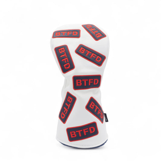 Golf driver cover with navy and red embroidered 'BTFD' patches on white background