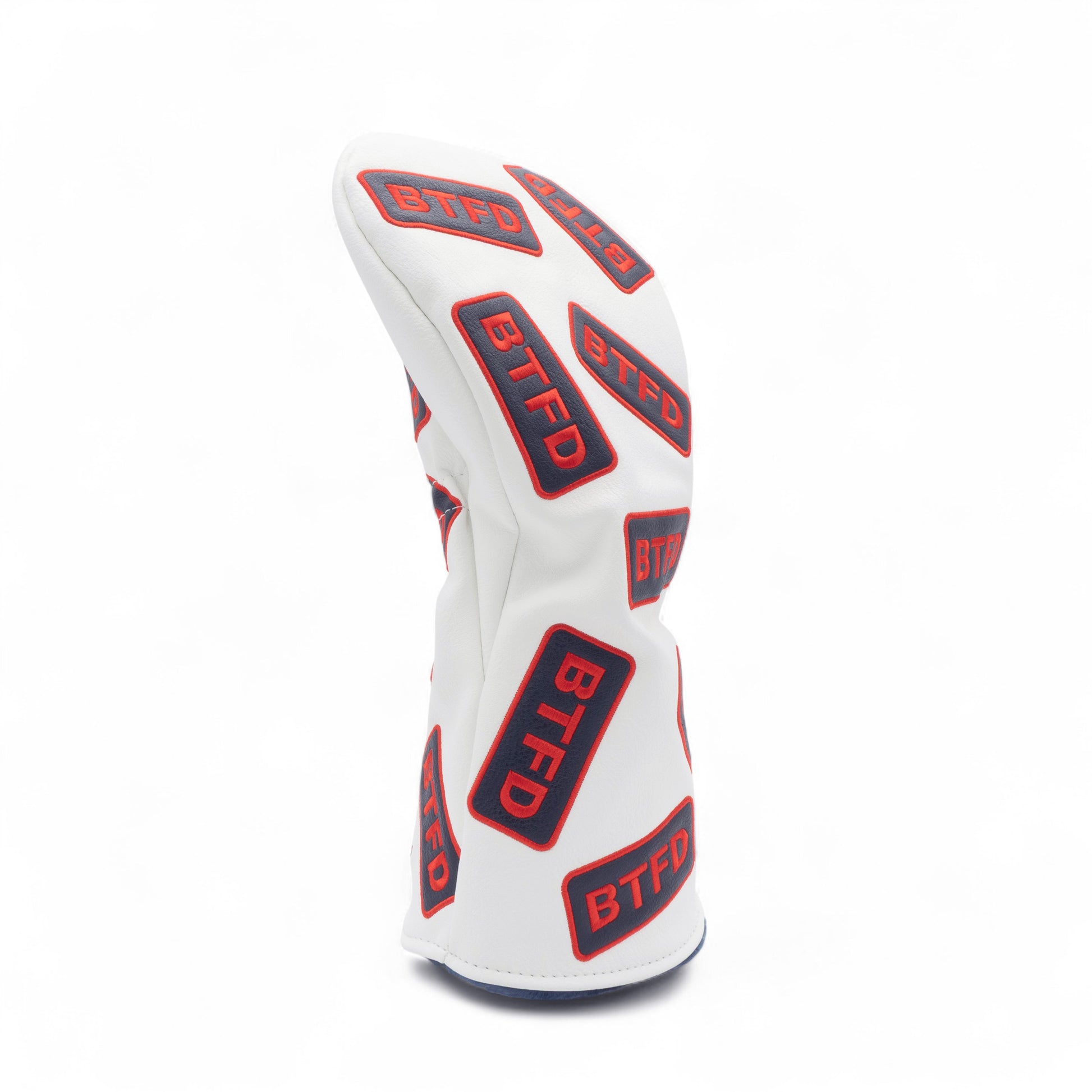 Golf driver cover with navy and red embroidered 'BTFD' patches on white background