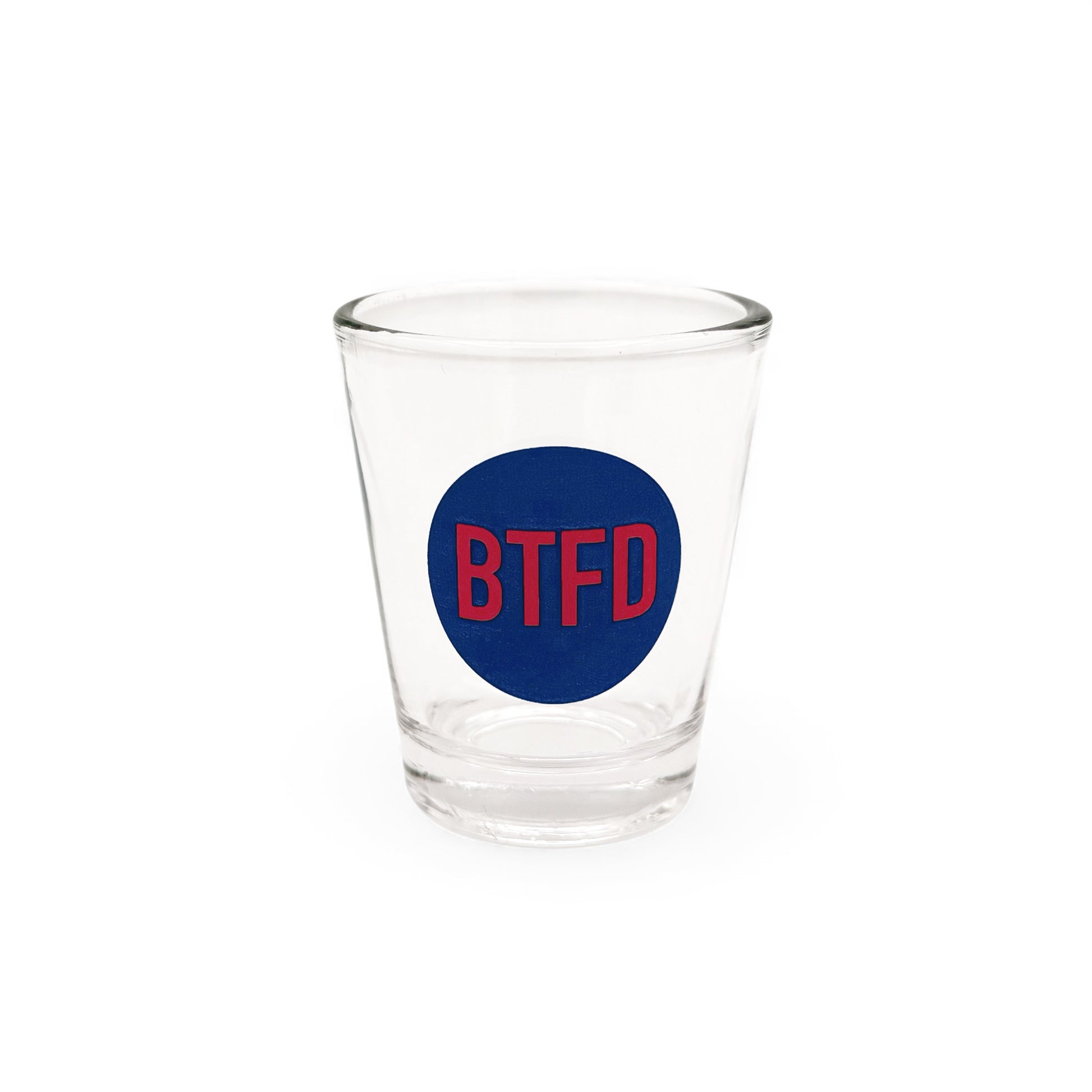 Clear shot glass with a blue circle and red text 'BTFD' on a white background