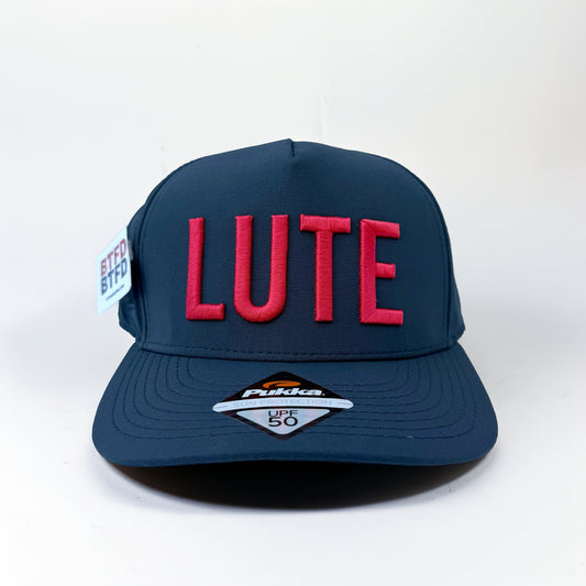 Blue cap with red 'LUTE' text on a white background