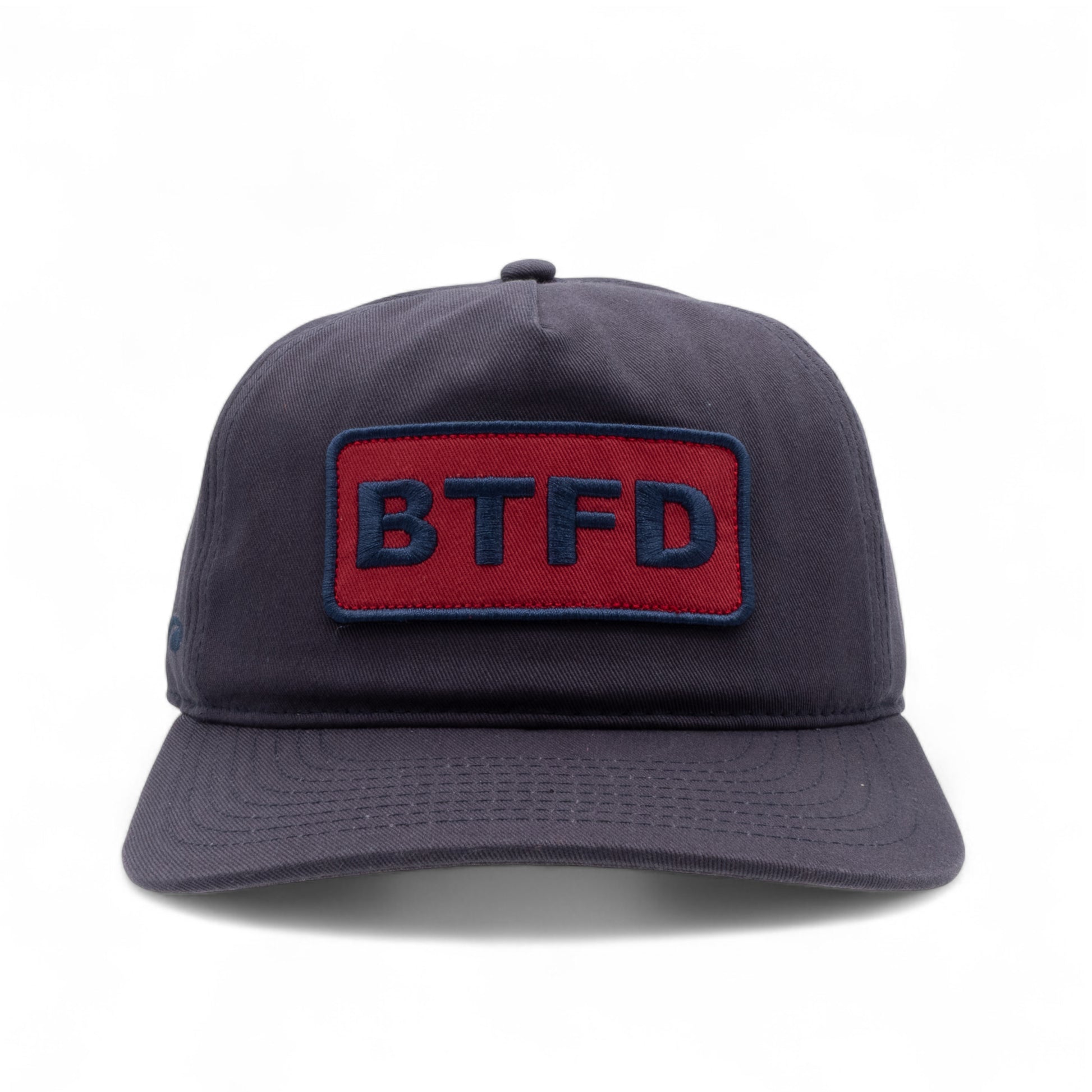Navy blue cotton twill cap with a red and blue 'BTFD' embroidered patch on a white background