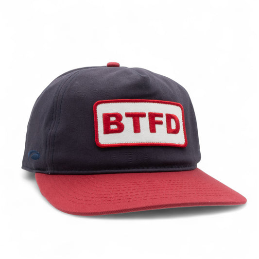 Navy and red cotton twill cap with 'BTFD' patch on a white background