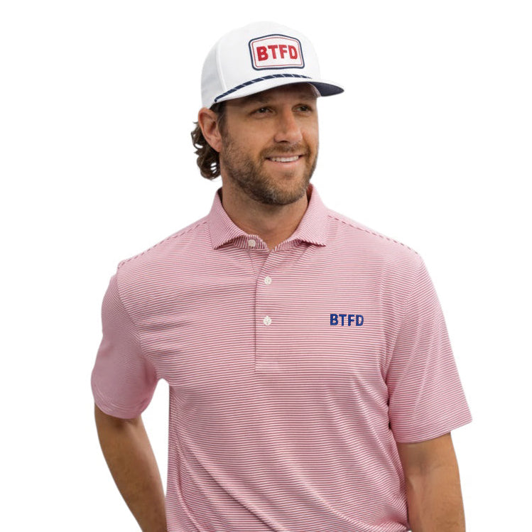 Man wearing a red/white striped polo shirt and white cap with 'BTFD' logo on a white background
