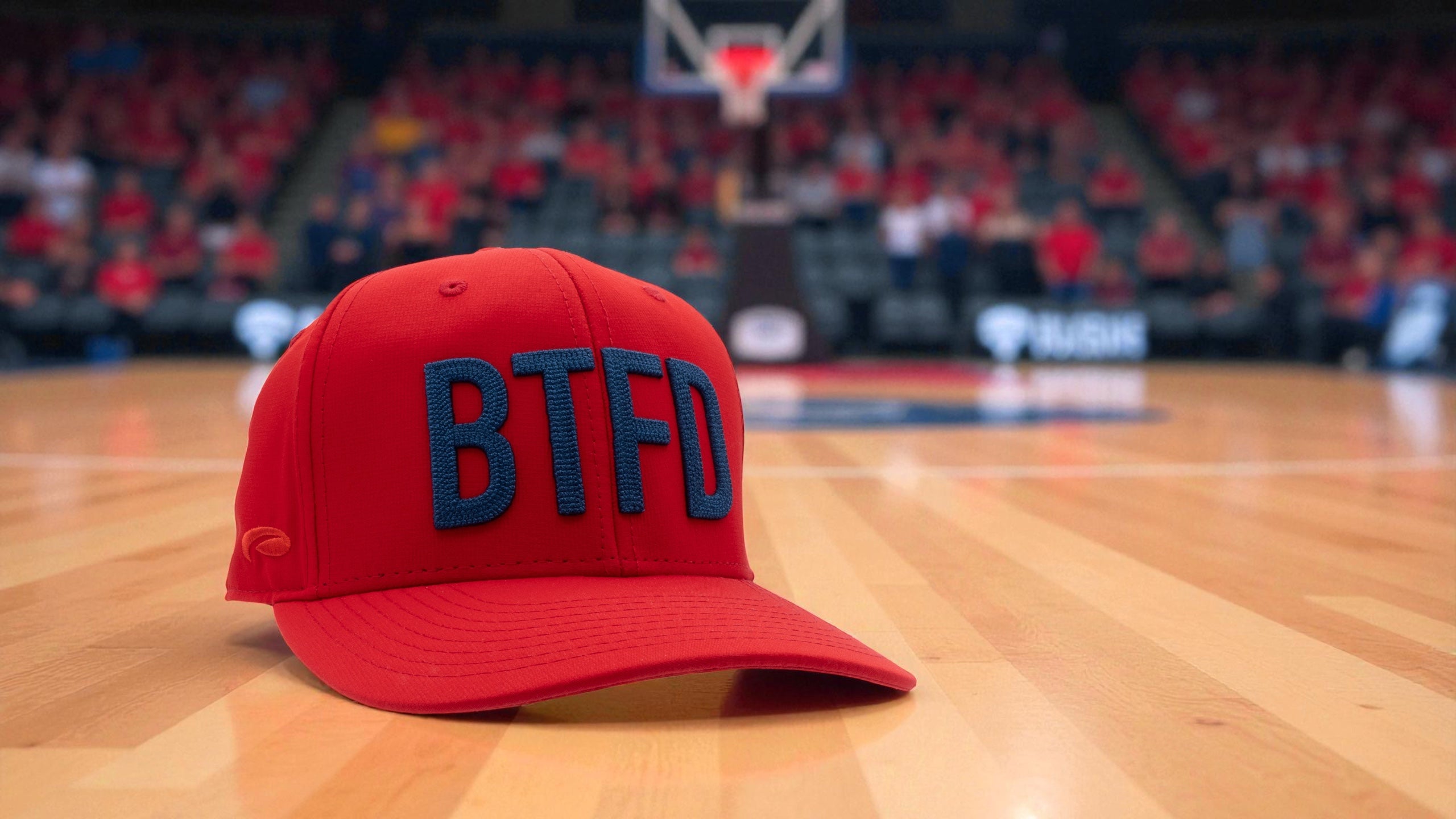 Red cap with 'BTFD' on a basketball court