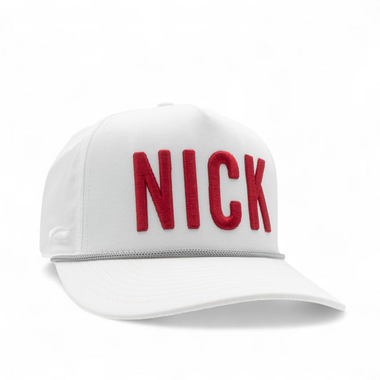 White cap with crimson 'NICK' text on a white background