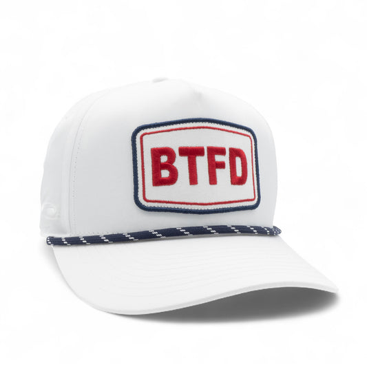 White trucker hat with a red and blue embroidered patch displaying 'BTFD' on a white background